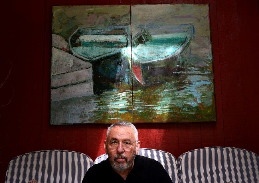 Tony Mendez in front of one of his paintings